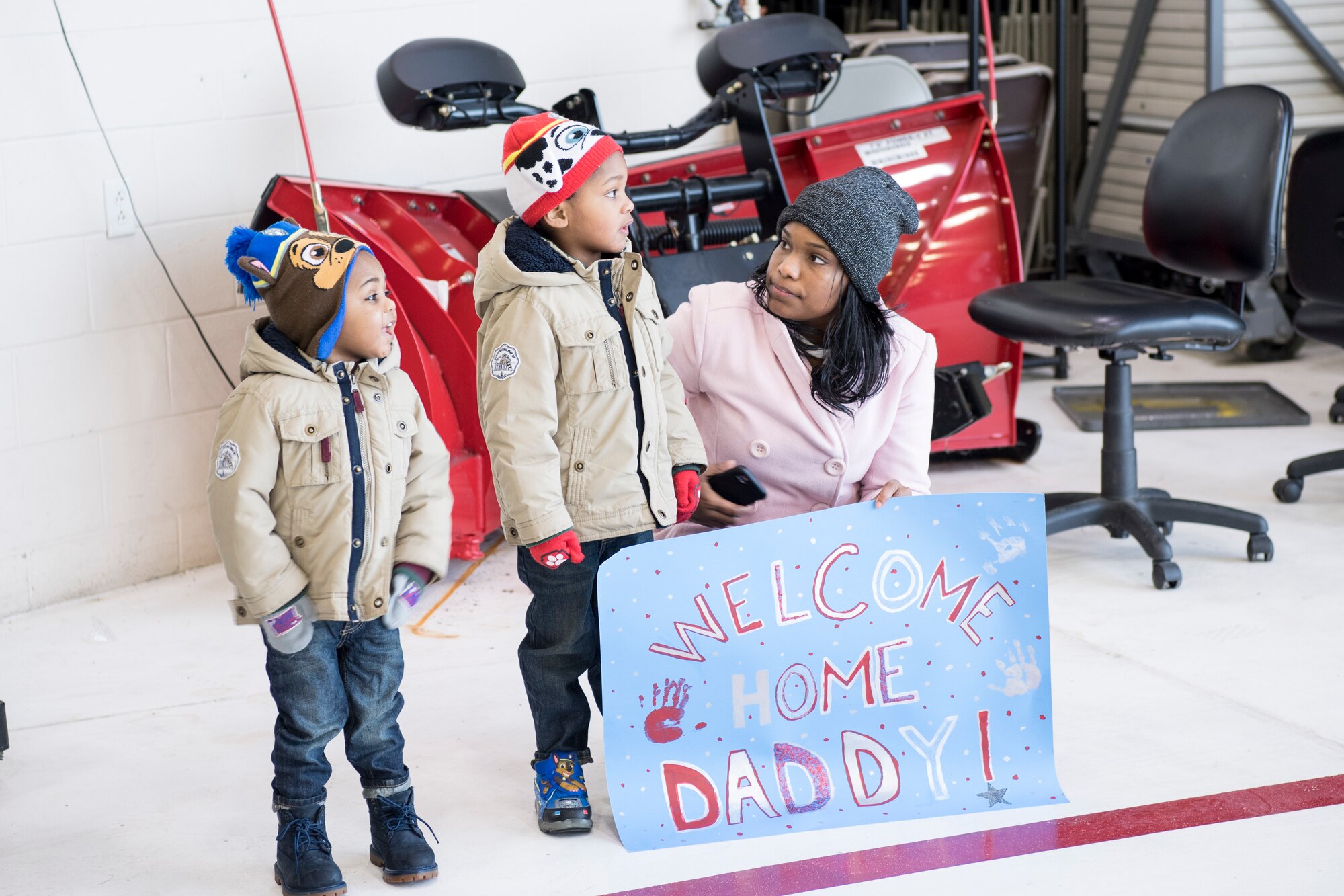 The family of a deployed Airmen wait for their loved one at Grissom Air Reserve Base, Indiana, Jan. 13, 2019. Team Grissom rallied to help get 18 deployers home on time despite weather and mechanical obstacles. (U.S. Air Force photo/Master Sgt. Ben Mota)