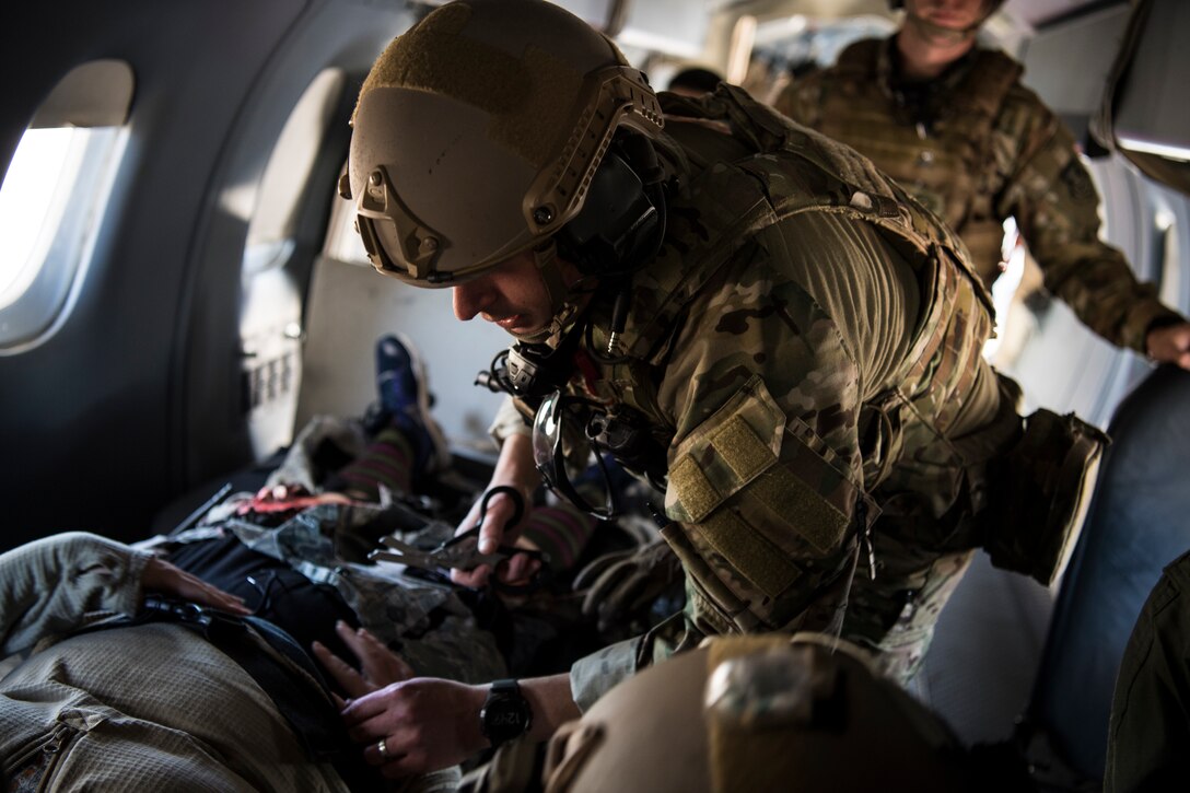 Three people in the back of an aircraft.