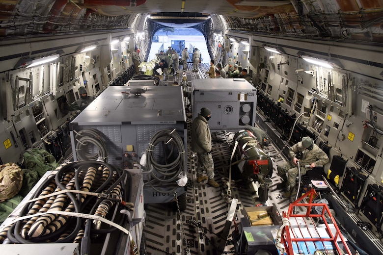 Members of the 8th Logistics Readiness Squadron load cargo onto a C-17 Globemaster III at Kunsan Air Base, Republic of Korea, Jan. 15, 2019. The 8th LRS helped load and ensured passenger were ready prior to departure. (U.S. Air Force photo by Staff Sgt. Joshua Edwards)