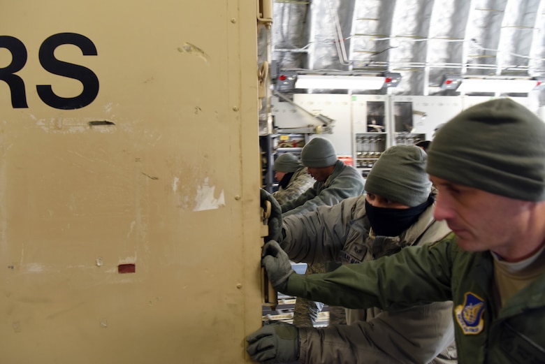 Members of the 8th Logistics Readiness Squadron load cargo onto a C-17 Globemaster III at Kunsan Air Base, Republic of Korea, Jan. 17, 2019. The 8th LRS support the loading and unloading transient aircraft that flow through the base. (U.S. Air Force photo by Staff Sgt. Joshua Edwards)
