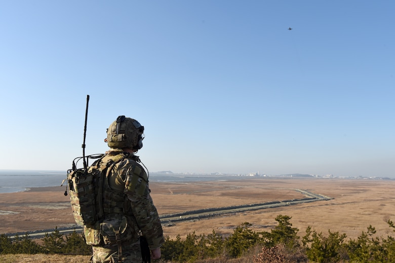 U.S. Air Force Senior Airman Brian Daum, 604th Air Support Operations Squadron tactical air control party member, calls in an F-16 Fighting Falcon during routine training at Kunsan Air Base, Republic of Korea, Jan. 23, 2019. Daum called for a fly over and also provided coordinates for a simulated air strike. (U.S. Air Force photo by Staff Sgt. Joshua Edwards)
