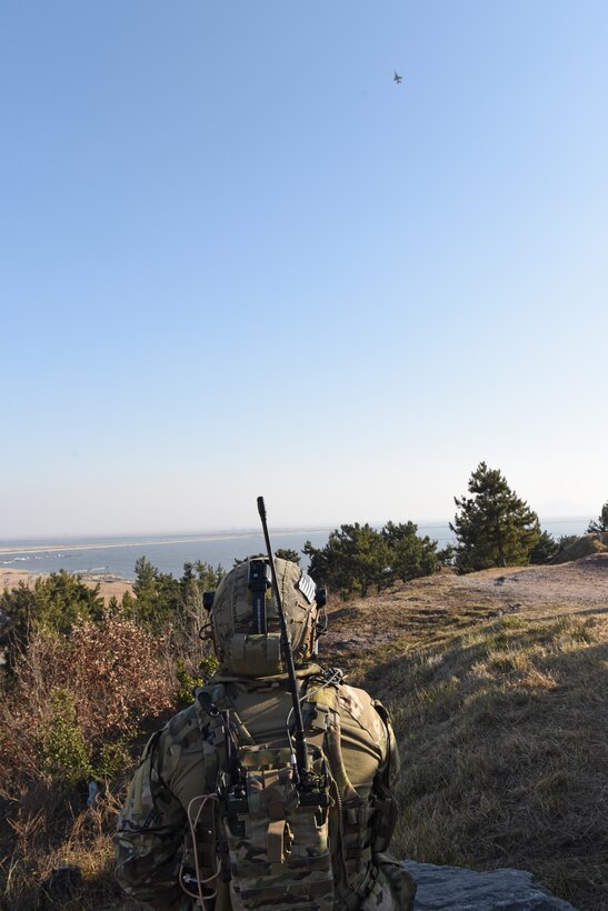 U.S. Air Force Senior Airman Brian Daum, 604th Air Support Operations Squadron tactical air control party member, watches an F-16 Fighting Falcon after a simulated air strike at Kunsan Air Base, Republic of Korea, Jan. 23, 2019. Airmen from the 604th ASOS TACP visited Kunsan to participate in a training event with Wolf Pack F-16s. (U.S. Air Force photo by Staff Sgt. Joshua Edwards)