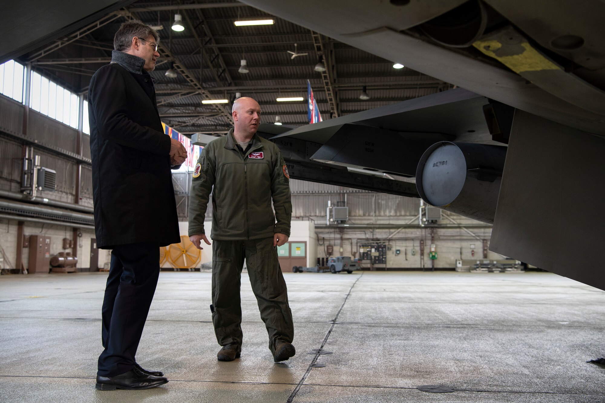 U.S. Air Force Lt. Col. David Welt, 52nd Operations Support Squadron director of operations, right, speaks with Patrick Schnieder, member of the German Federal Parliament in Berlin, left, in Hangar 1 at Spangdahlem Air Base, Germany, Jan. 24, 2019. Welt showed Schnieder functions of a F-16 Fighting Falcon. Schnieder was provided with a 52nd Fighter Wing mission brief and visited several locations on base. (U.S. Air Force photo by Airman 1st Class Valerie Seelye)