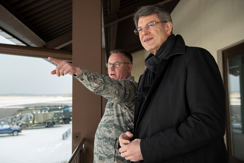 U.S. Air Force Lt. Col. Shannon Caleb, 726th Air Mobility Squadron commander, left, speaks with Patrick Schnieder, member of the German Federal Parliament in Berlin, right, at the passenger terminal at Spangdahlem Air Base, Germany, Jan. 24, 2019. Caleb explained how the 726th AMS operates in conjunction with the 52nd Fighter Wing. (U.S. Air Force photo by Airman 1st Class Valerie Seelye)