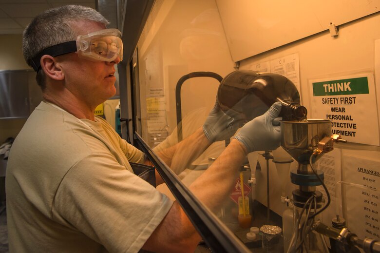 Tech. Sgt. Steven Jenkins, 379th Expeditionary Logistics Readiness Squadron fuels lab NCO in charge, performs a ‘bottle method’ during fuel testing Jan. 24, 2019, at Al Udeid Air Base, Qatar. As part of his job, Jenkins analyzes various fuel types including gasoline, diesel fuel and Jet Propellant 8, to ensure they are free of contaminants before use in aircraft and vehicles. Airmen from the 379th ELRS fuel lab retrieve samples for testing from various sources including pipelines, trucks and fuel tanks.   (U.S. Air Force photo by Tech. Sgt. Christopher Hubenthal)