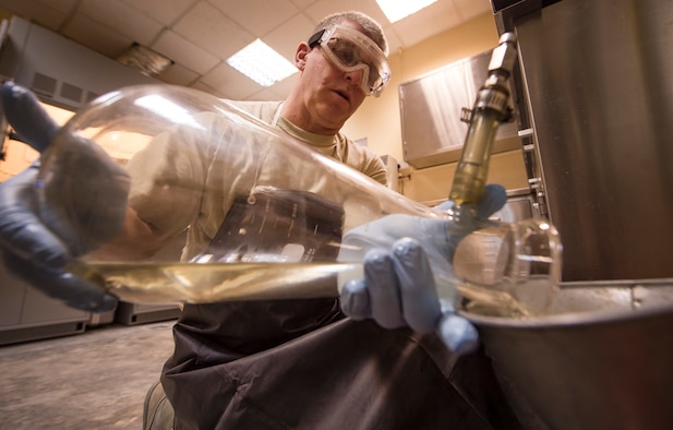 Tech. Sgt. Steven Jenkins, 379th Expeditionary Logistics Readiness Squadron (ELRS) fuels lab NCO in charge, dumps recoverable Jet Propellant 8 (JP-8) after completing a ‘bottle method’ as part of a fuel inspection Jan. 24, 2019, at Al Udeid Air Base, Qatar. As part of his job, Jenkins analyzes various fuel types including gasoline, diesel fuel and Jet Propellant 8, to ensure they are free of contaminants before use in aircraft and vehicles. Airmen from the 379th ELRS fuel lab retrieve samples for testing from various sources including pipelines, trucks and fuel tanks.   (U.S. Air Force photo by Tech. Sgt. Christopher Hubenthal)