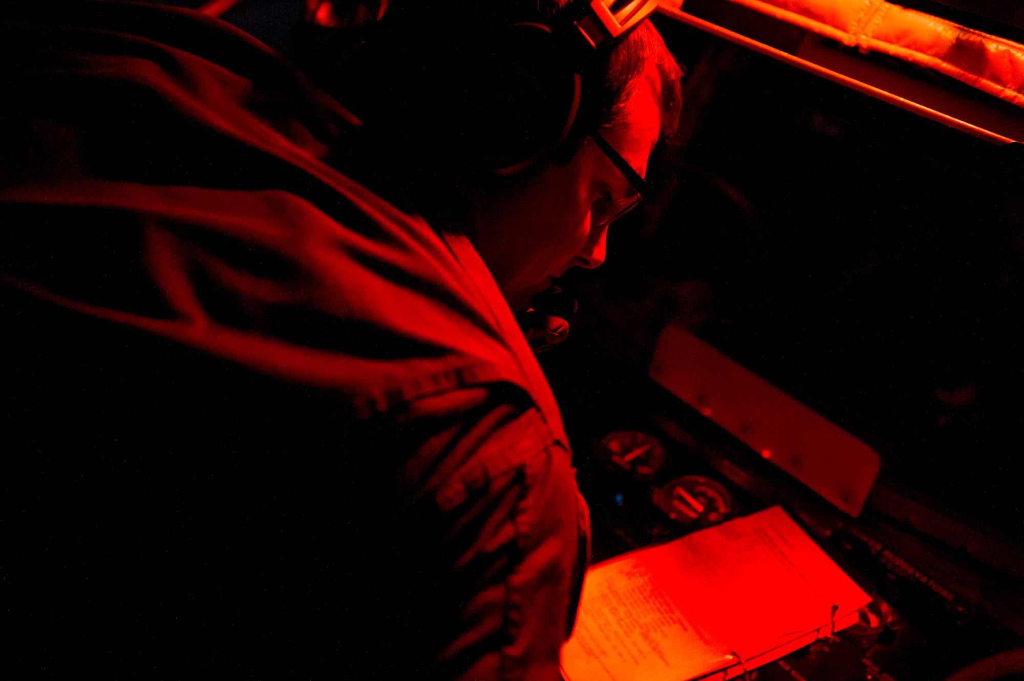 U.S. Air Force Staff Sgt. Jeffrey Michal, a 50th Air Refueling Squadron boom operator, reviews his post-aerial refueling checklist after successfully refueling an MC-130H Combat Talon II aircraft during a night mission in support of Exercise Emerald Warrior, Jan. 17, 2019.