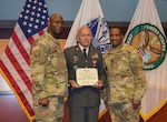 Maj. Gen. Mitchell L. Kilgo, U.S. Central Command’s Army element commander, left, and Command Sgt. Maj. Charles Ivey, U.S. Central Command’s Army element senior enlisted leader, right, stand with retired Sgt. 1st Class Mario Olivo during a ceremony at U.S. Central Command headquarters, Jan. 22, 2019. Olivo was awarded a Bronze Star medal for service with Charlie Company, 1st Battalion, 52nd Infantry in the Republic of Vietnam from Jan. 1971 until Oct. 1971.