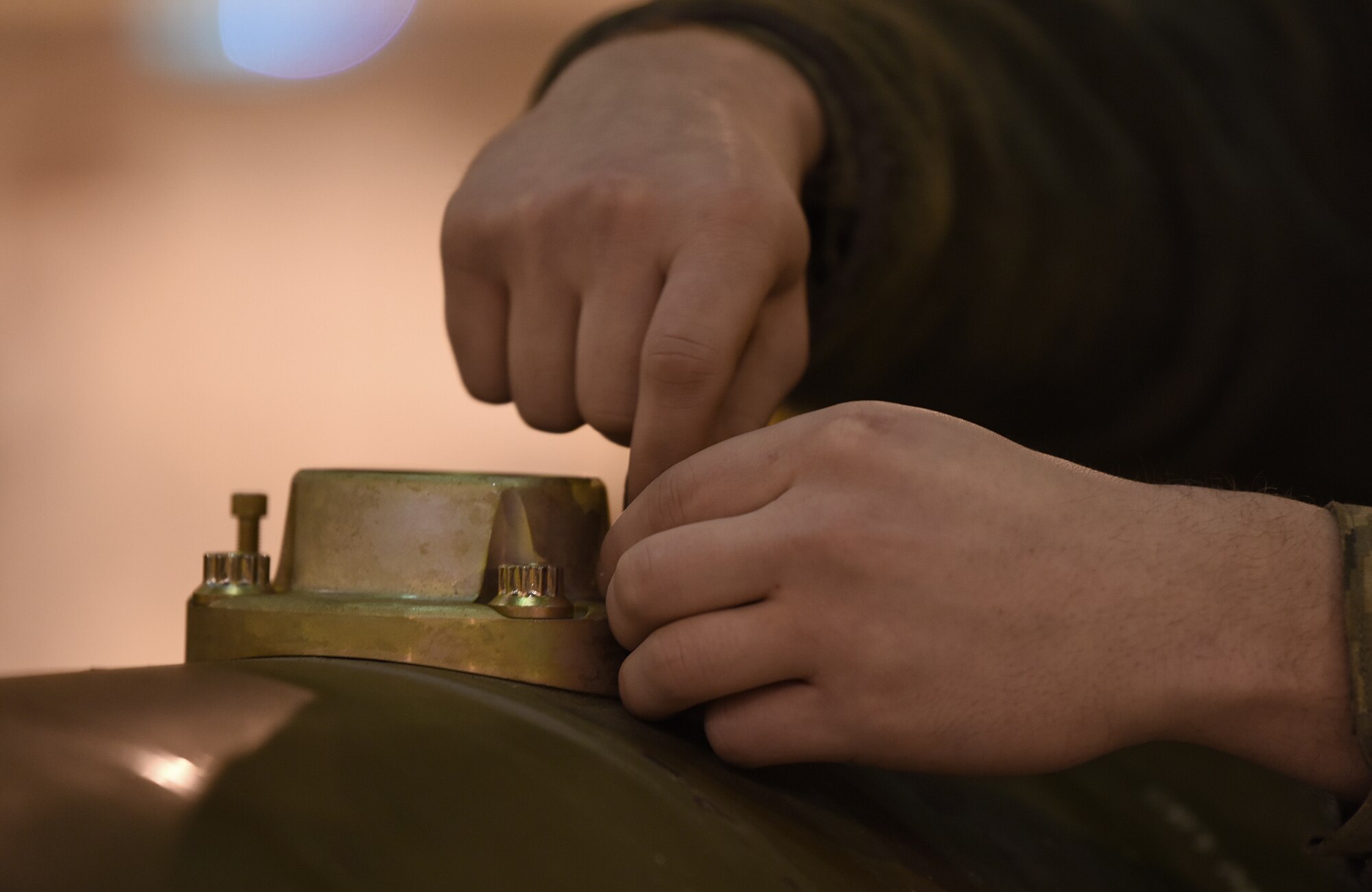 A 48th Munitions Squadron Airman fastens parts together on an inert weapon at Royal Air Force Lakenheath, England, Jan. 23, 2019. MUNS Airmen have been training and preparing for the Air Force Combat Operations Competition scheduled for May at Beale Air Force Base, Calif. (U.S. Air Force photo by Airman 1st Class Madeline Herzog)