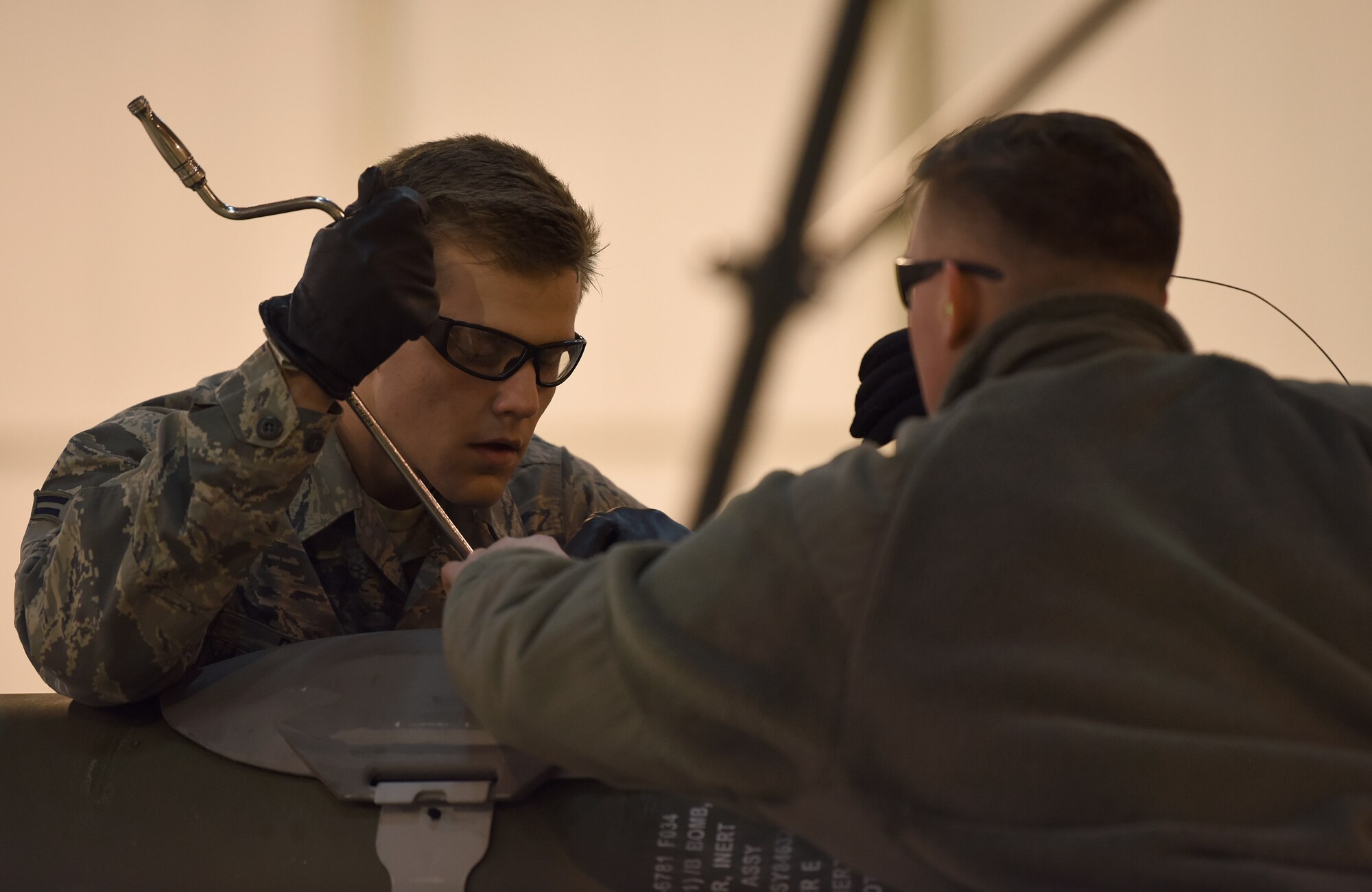 Airman 1st Class Cody Roach, 48th Munitions Squadron specialist, secures the hardback assembly on an inert ordnance at Royal Air Force Lakenheath, England, Jan. 23, 2019. Participants were hand selected by section noncommissioned officers in charge and shop chiefs to represent the squadron. (U.S. Air Force photo by Airman 1st Class Madeline Herzog)