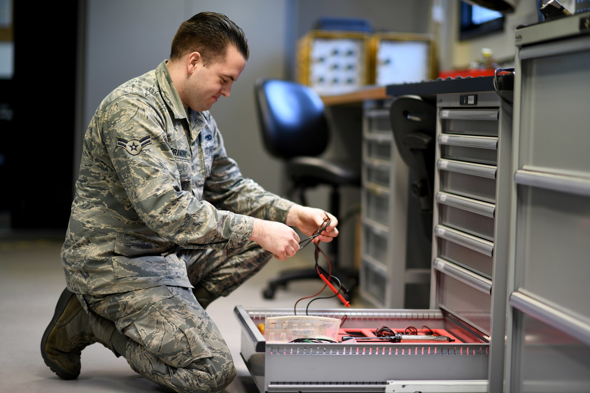 An Airman assigned to the 48th Component Maintenance Squadron’s Electrical and Environmental section retrieves test leads for an operations check on equipment at Royal Air Force Lakenheath, England, Jan. 23, 2019. The test leads are used to send a surge of energy into a component testing its capabilities before it is returned to service. (U.S. Air Force photo by Senior Airman Malcolm Mayfield)