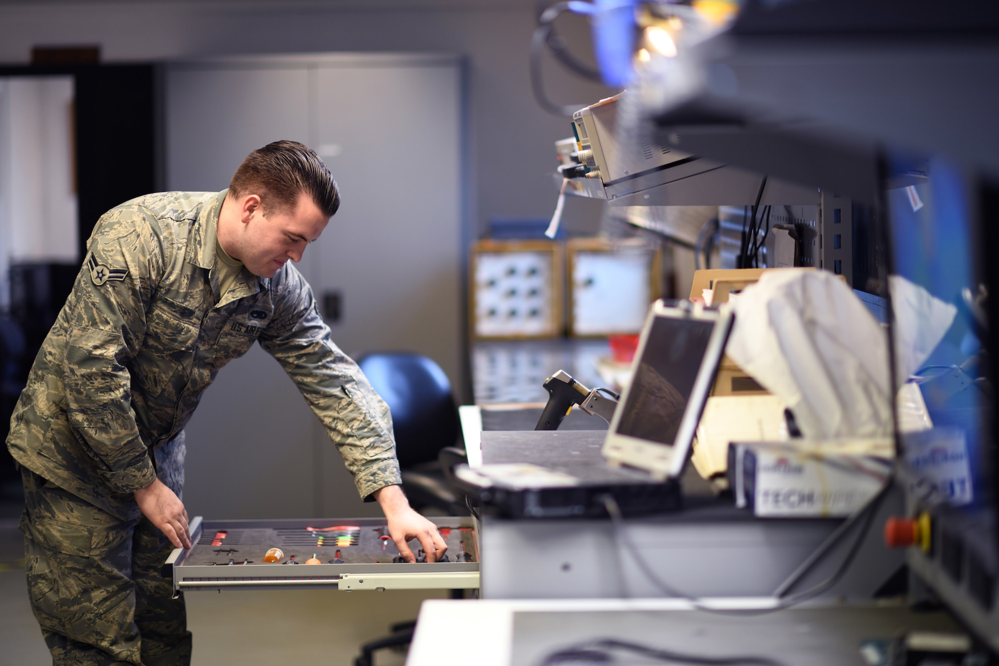 An Airman assigned to the 48th Component Maintenance Squadron’s Electrical and Environmental section searches for tools prior to an operations check on equipment at Royal Air Force Lakenheath, England, Jan. 23, 2019. The backshop provides support to over a dozen agencies, including the 492nd, 493rd and 494th Fighter Squadrons and the entire 48th Maintenance Group. (U.S. Air Force photo by Senior Airman Malcolm Mayfield)