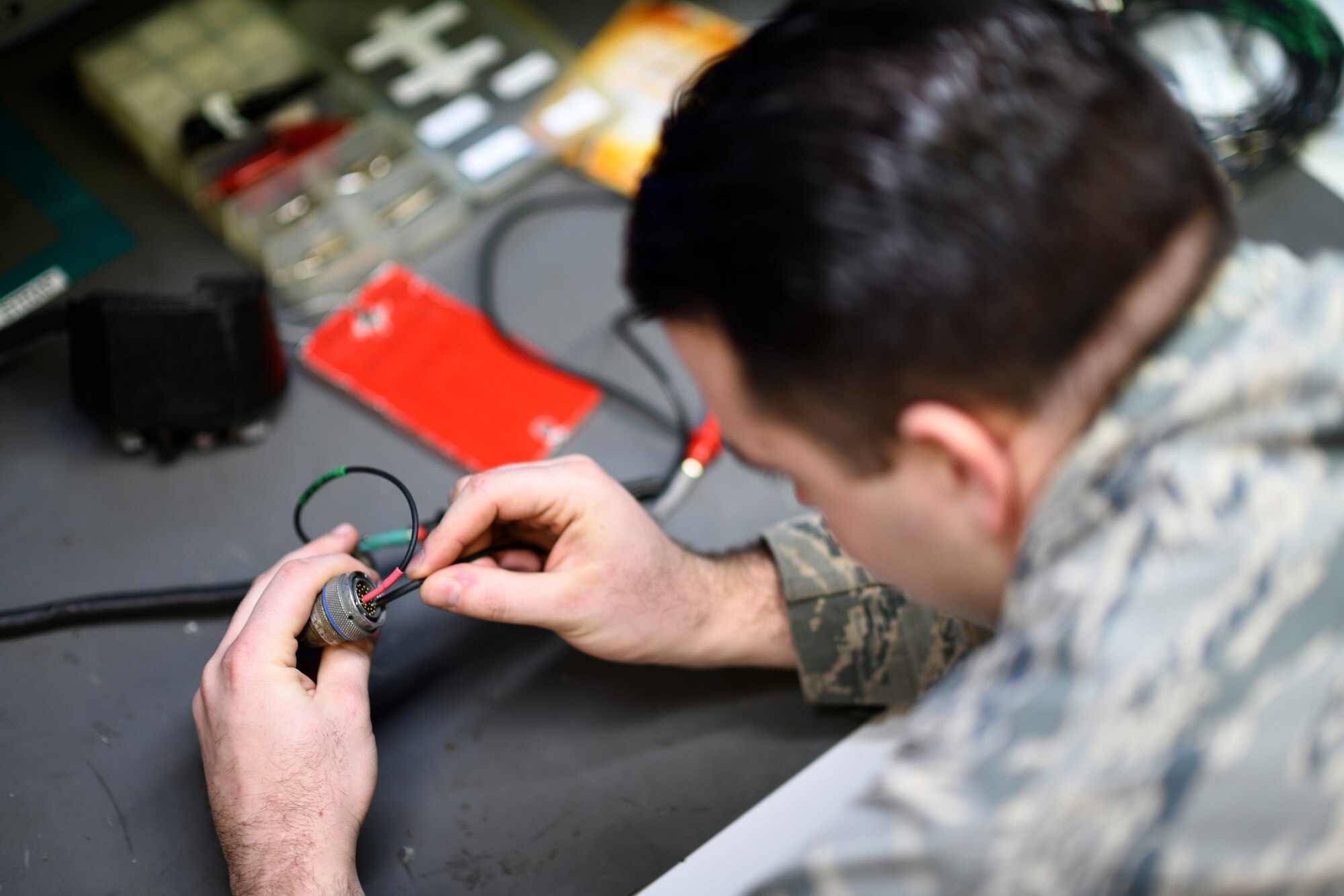 An Airman assigned to the 48th Component Maintenance Squadron’s Electrical and Environmental section uses test leads on a throttle grip during an operations check at Royal Air Force Lakenheath, England, Jan. 23, 2019. The backshop developed a local standard to alleviate the need to send the component to a stateside facility for repair, saving $5,000 each time it’s repaired. (U.S. Air Force photo by Senior Airman Malcolm Mayfield)