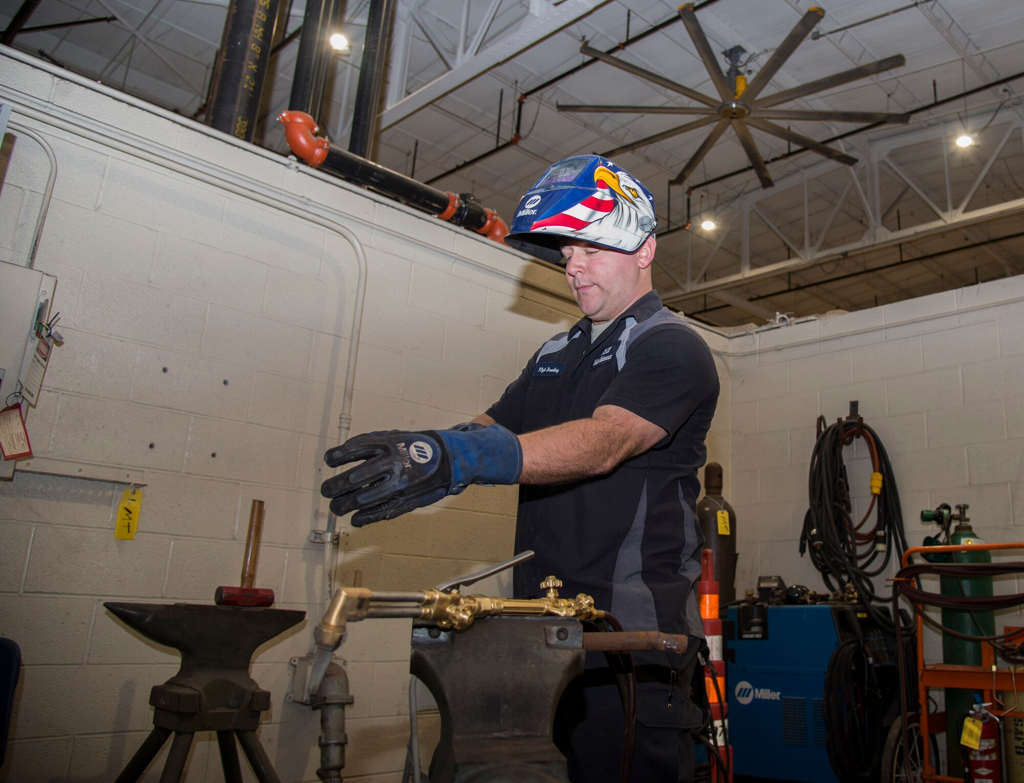 Tech. Sgt. Brian Bradley, 375th Logistics Readiness Squadron vehicle maintenance technician, puts on the required personal protective equipment before he starts welding Jan. 10, 2019, at Scott Air Force Base, Ill. Welding is used by the vehicle maintenance flight to fabricate parts out of raw materials, so they can be used to repair vehicles.