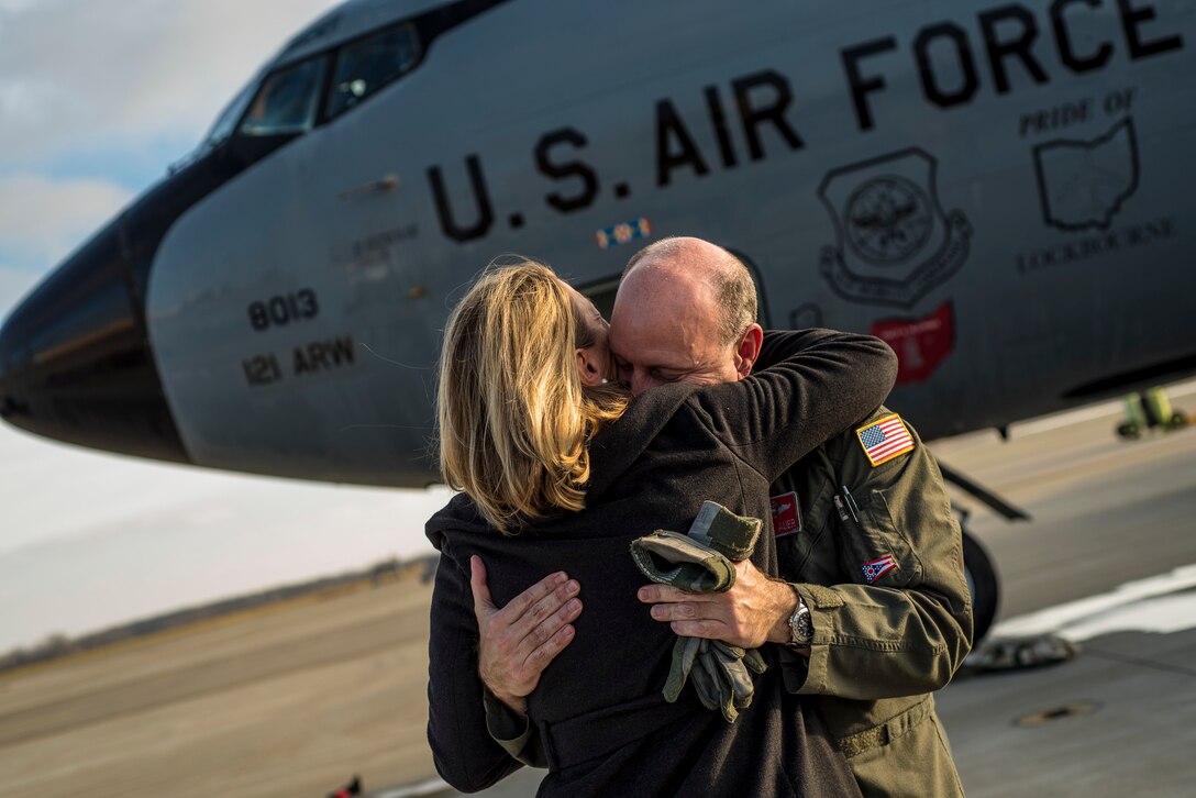 Col. Mark Auer, 121st Air Refueling Wing commander, hugs his wife, Nancy, after his final flight