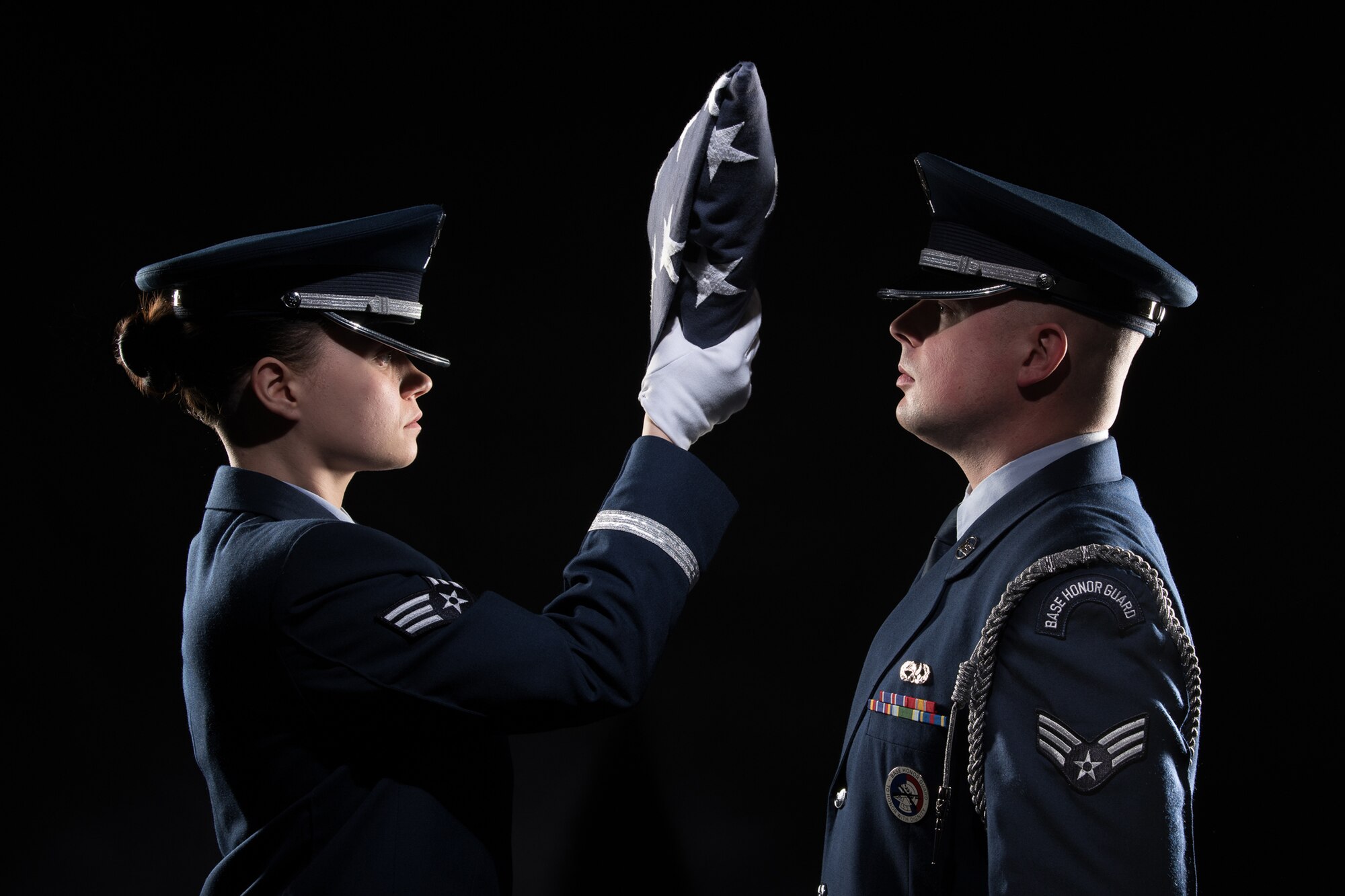 Honor guard members demonstrate a flag-folding ceremony