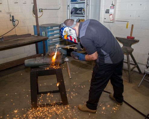 Tech Sgt. Brian Bradley, 375th Logistics Readiness Squadron vehicle maintenance technician, welds a steel bar in the fabrication workshop Jan.10, 2019, at Scott Air Force Base, Ill. Vehicle maintenance receives approximately five vehicles a week in need of repair.