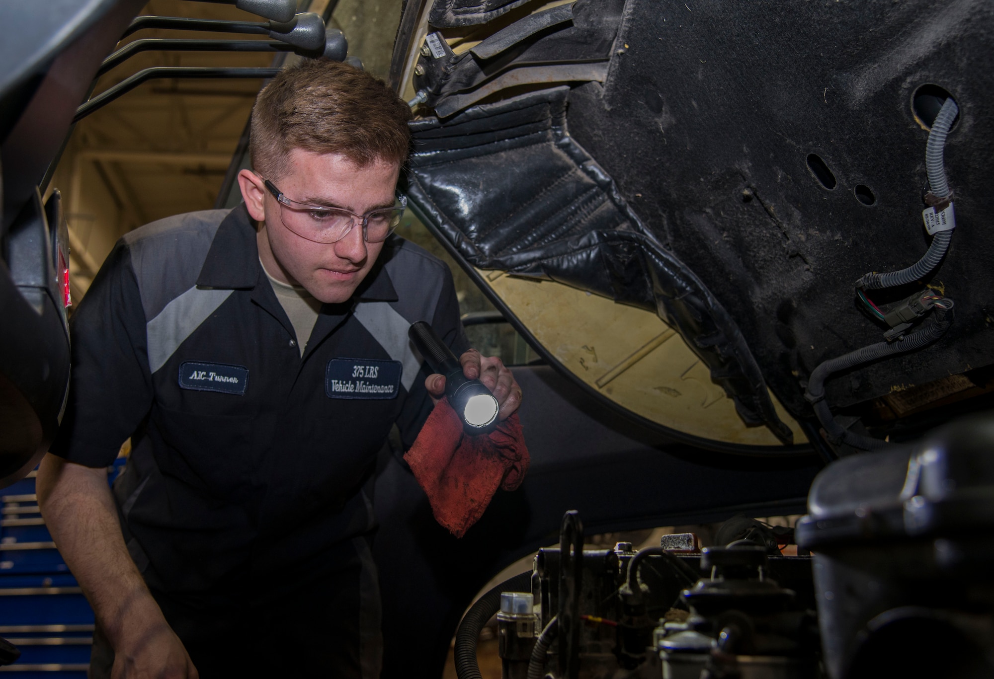 Airman 1st Class Aaron Turner, 375th Logistics Readiness Squadron vehicle maintenance technician, inspects the engine compartment of a forklift Jan. 10, 2019, at Scott Air Force Base, Ill. Turner inspects the vehicle by checking the oil, ensuring the parts aren’t damaged, and cleaning the grease and grime off of the engine parts.