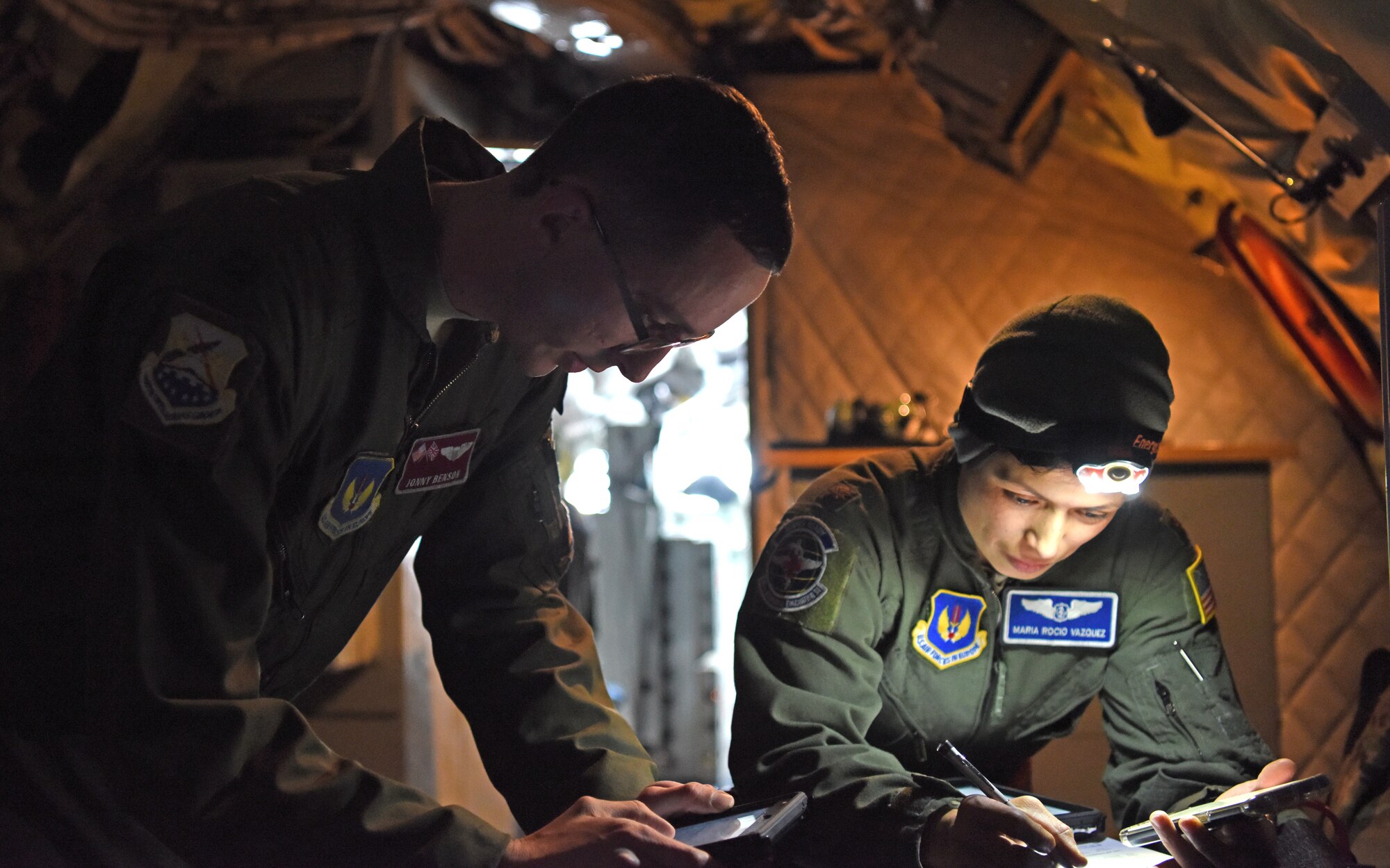 U.S. Air Force Capt. Jonny Benson, 351st Air Refueling Squadron KC-135 Stratotanker aircraft commander from RAF Mildenhall, England, and U.S. Air Force Maj. Maria Rocio Vazquez, 86th Aeromedical Evacuation Squadron medical crew director from Ramstein Air Base, Germany, discuss pre-flight checklists prior to aeromedical evacuation training over the skies of Germany, Jan. 23, 2019. During the training, members underwent emergency medical scenarios, including patients suffering worsening health conditions, cardiac emergencies, aircraft decompression and emergency ditching of aircraft. (U.S. Air Force photo by Airman 1st Class Brandon Esau)
