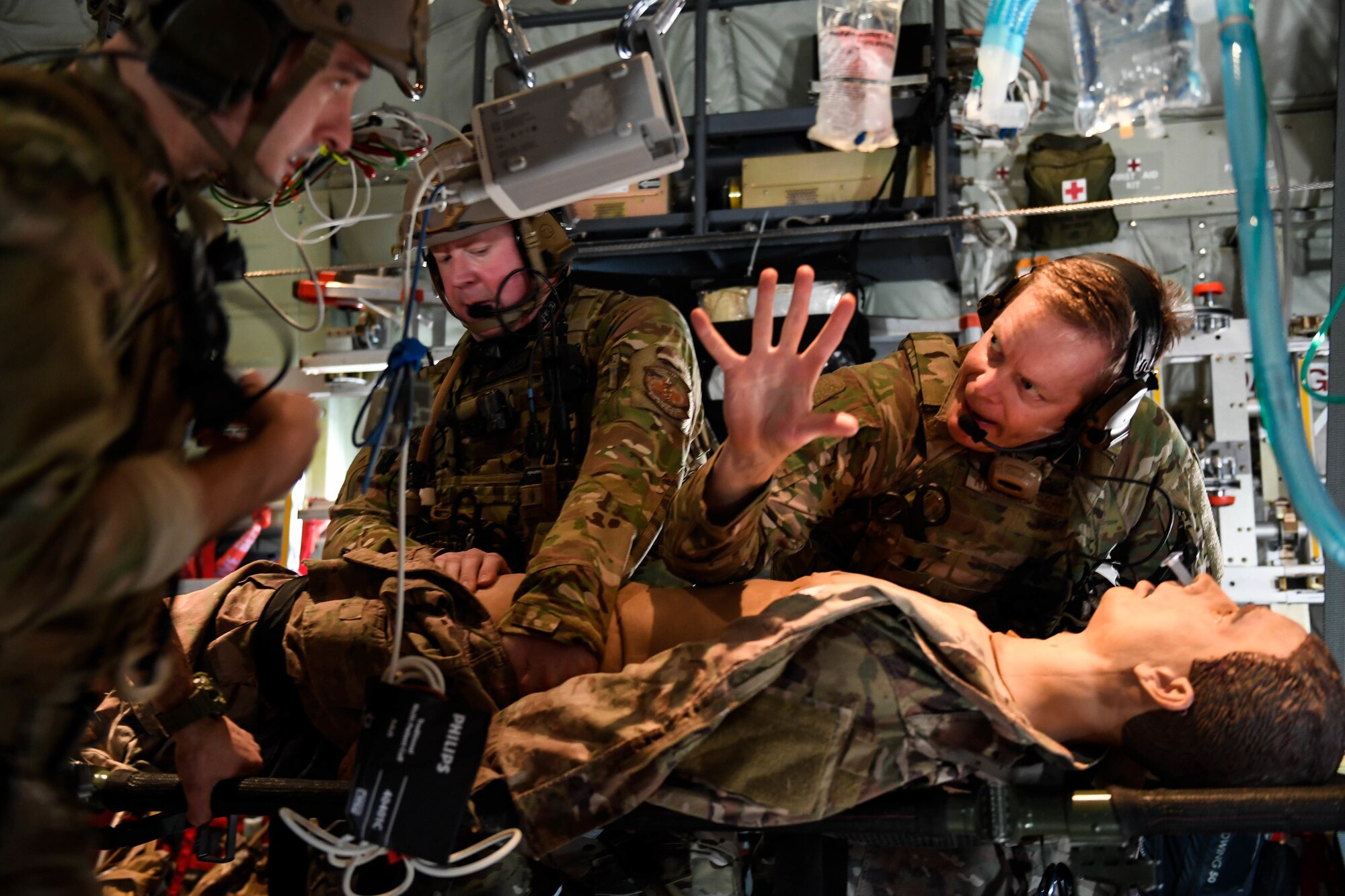 Maj. John Richardson, right, 27th Special Operations Support Squadron physician, practices medical care on a simulated patient during exercise Emerald Warrior/Trident