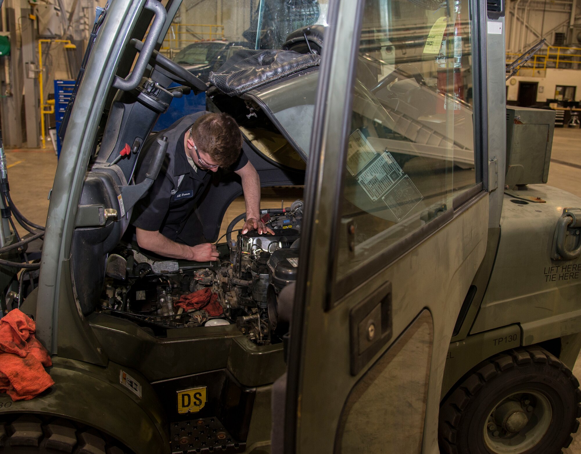 Airman 1st Class Aaron Turner, 375th Logistics Readiness Squadron vehicle maintenance technician, inspects one of the engine parts on a forklift Jan. 10, 2019, at Scott Air Force Base, Ill. The vehicle maintenance flight is comprised of 14 Airmen and civilians who are responsible for ensuring that all the vehicles assigned to Scott are working and are properly maintained.