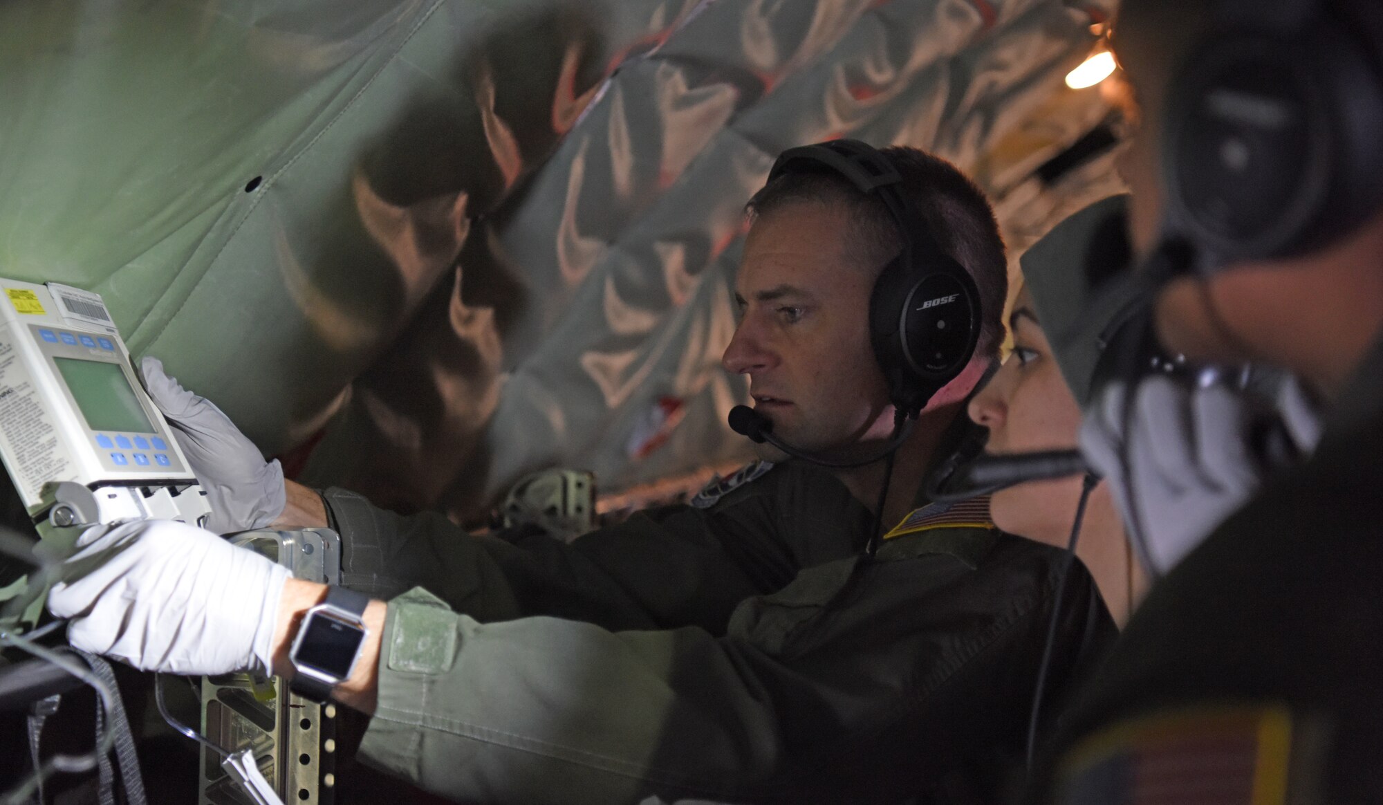 U.S. Air Force Maj. Jeremy Hicks, left, 86th Aeromedical Evacuation Squadron flight nurse, shows members of the 86th AES how to administer intravenous bags during training aboard a KC-135 Stratotanker over the skies of Germany, Jan. 23, 2019. The 86th AES are charged with providing aeromedical care for both U.S. European Command and U.S. Africa Command, which is the largest area of responsibility out of all existing aeromedical evacuation squadrons. (U.S. Air Force photo by Airman 1st Class Brandon Esau)