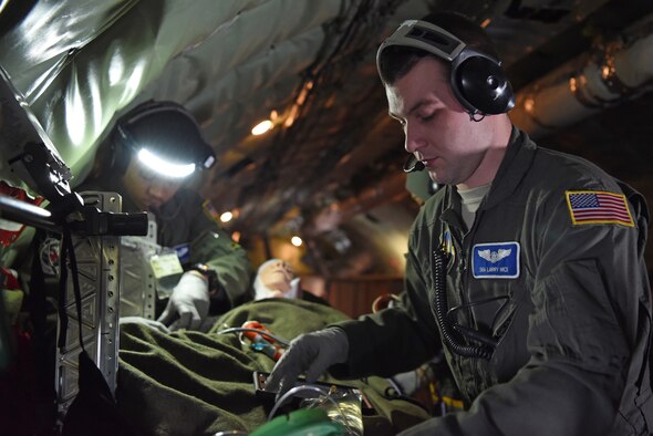 U.S. Air Force Staff Sgt. Yannick Sharras, left, 86th Aeromedical Evacuation Squadron medical technician from Ramstein Air Base, Germany, and U.S. Air Force Senior Airman Larry Nice, 86th AES medical technician, prepare a patient for medical evacuation during training aboard a KC-135 Stratotanker over the skies of Germany, Jan. 23, 2019. During the training, members underwent emergency medical scenarios, including patients suffering worsening health conditions, cardiac emergencies, aircraft decompression and emergency ditching of aircraft. (U.S. Air Force photo by Airman 1st Class Brandon Esau)