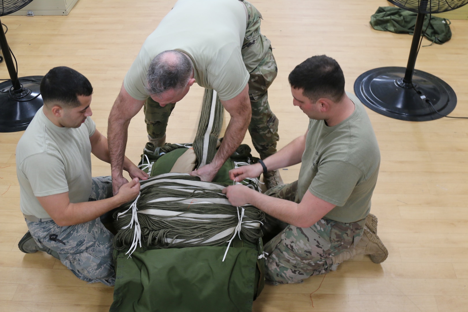 The G12E Parachute is the focus of cross-training for Soldiers from the 56th Quartermaster Rigger Support Team, RI Army National Guard and their RI Air National Guard counterparts, January 5, 2019, Quonset Point, North Kingstown RI. Training on the G12E Cargo Parachute increases proficiency on air drop systems and improves interoperability.  (U.S. Army National Guard Photo by Sgt. 1st Class Michael A. Simmons)