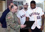 Sgt. 1st Class Daniel Peters (left) describes the mission and capabilities of the U.S. Army Institute of Surgical Research Burn Center Burn Flight Team to Houston Astros pitchers Dean Deetz, Rogelio Armenteros and Astros broadcaster Alex Trevino during their visit to the U.S. Army Institute of Surgical Research Burn Center at Joint Base San Antonio-Fort Sam Houston Jan. 24.