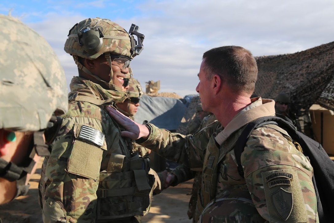 U.S. Army Command Sgt. Maj. William F. Thetford, U.S. Central Command senior enlisted leader, presents coins to U.S. Army Soldiers during a training exercise in Iraq, Jan. 16, 2019. The Soldiers are deployed in support of Operation Inherent Resolve, working by, with and through the Iraqi Security Forces and Coalition partners to defeat ISIS in areas of Iraq and Syria. ( U.S. Army photo by Sgt. Franklin Moore)