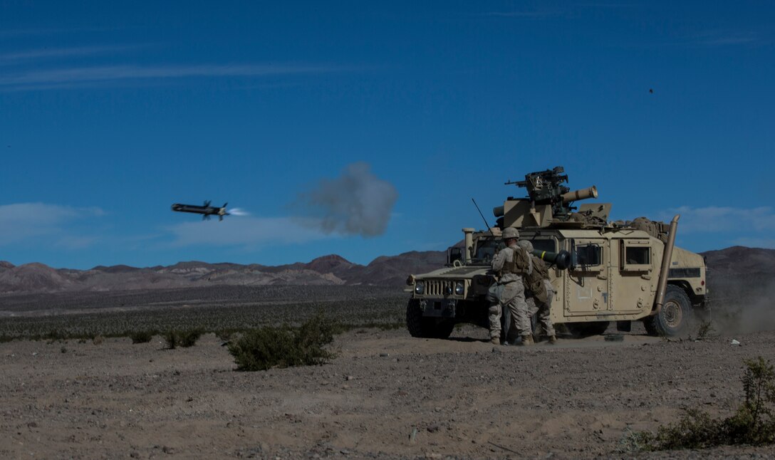 U.S. Marine Corps Cpl. Joseph Magee, left, and Cpl. Andy E. Coussens, with combined anti-armored team, 2nd Battalion, 7th Marine Regiment, 1st Marine Division, fires a tow missile, during exercise Steel Knight (SK) 2019 at Marine Corps Air Ground Combat Center, Twentynine Palms, California, Dec. 4, 2018.