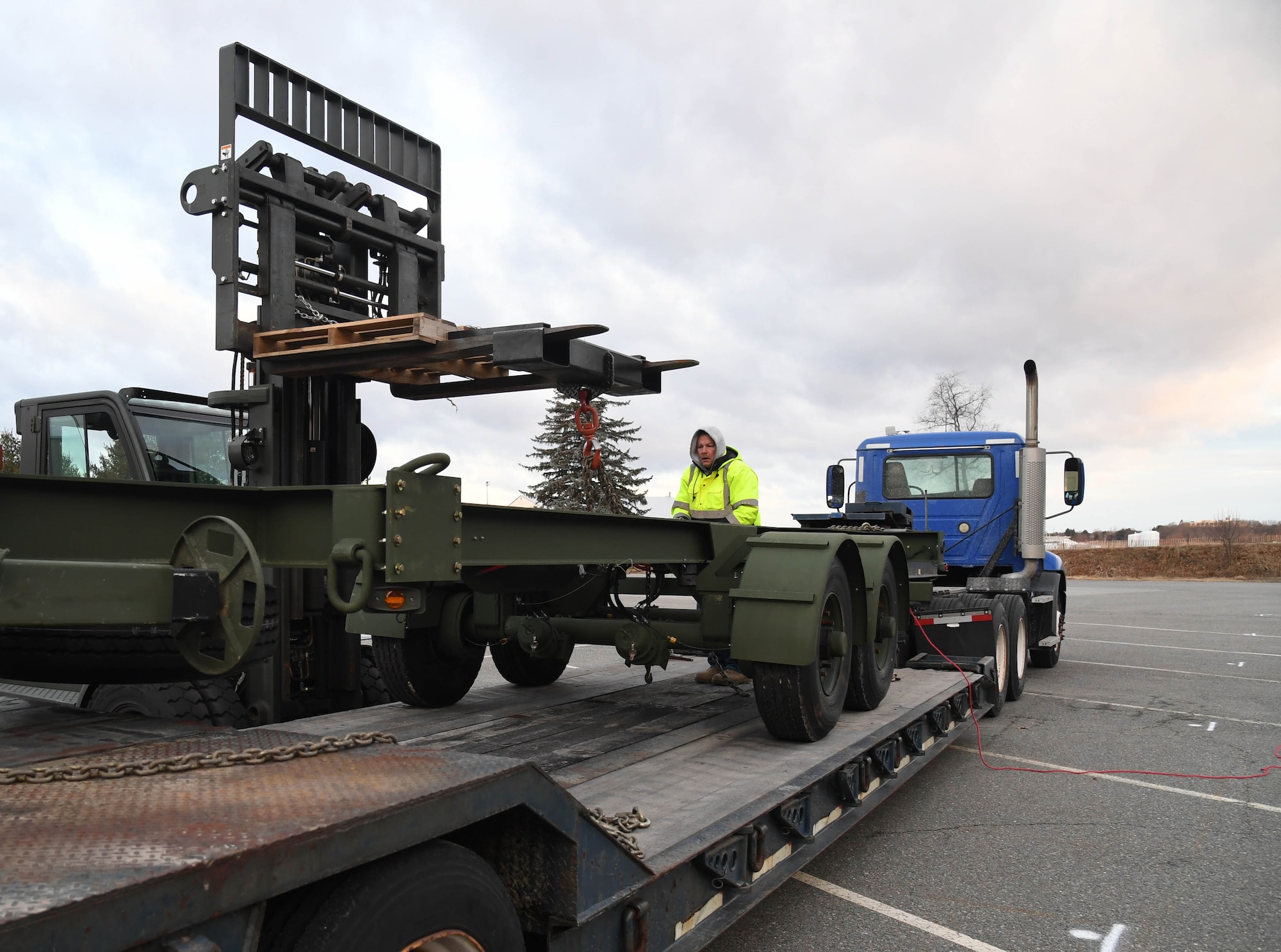 66th Air Base Group Logistics Readiness Squadron employees coordinate the unloading of a testing trailer Jan. 10, 2019, at Hanscom Air Force Base, Mass. Program Executive Office Digital purchased the trailer to test loading and delivery characteristics for the Three Dimensional Expeditionary Long Range Radar, or 3DELRR. (U.S. Air Force photo by Linda LaBonte Britt)