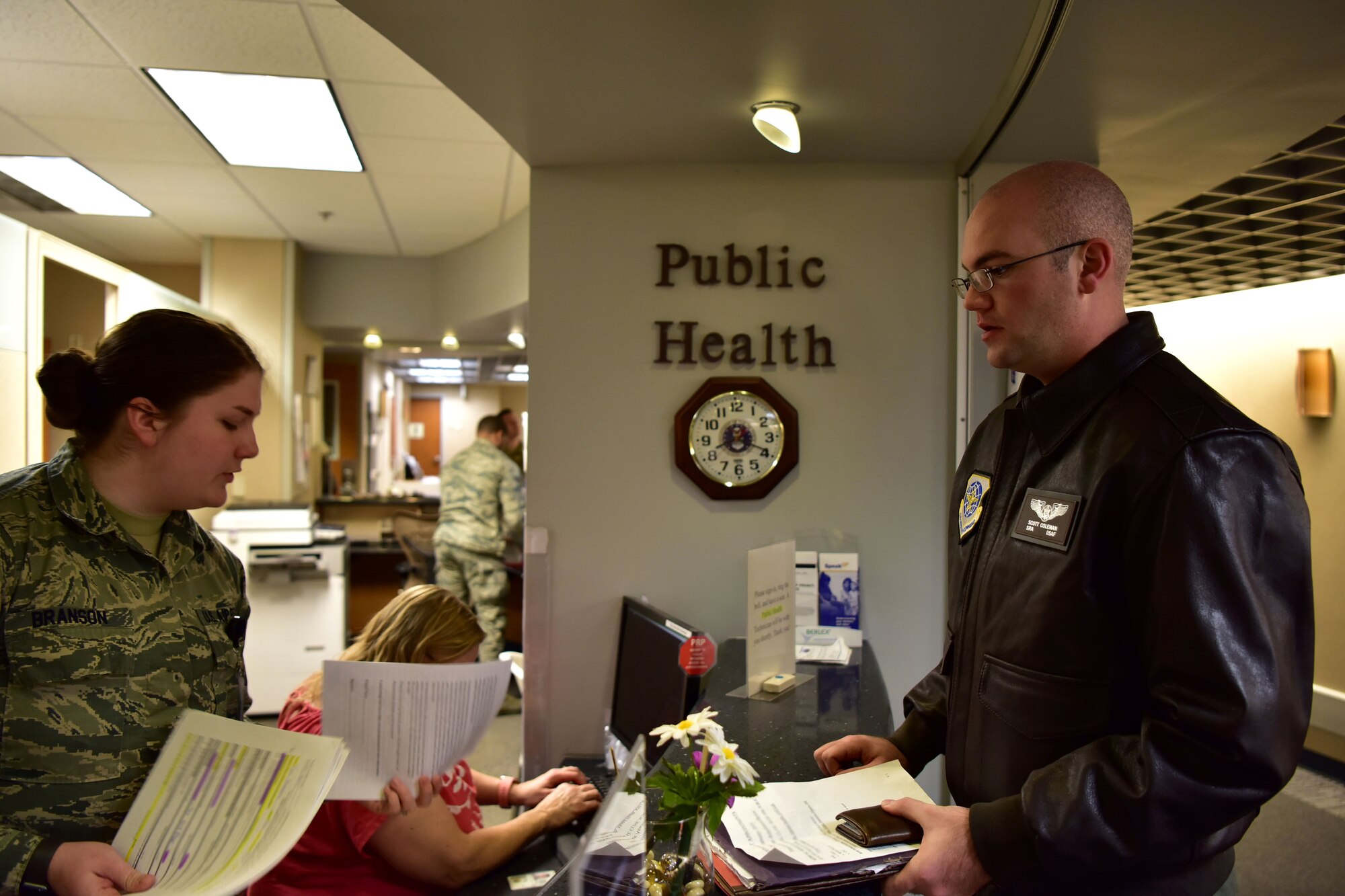 An Airman turns in paperwork at the public health clinic.
