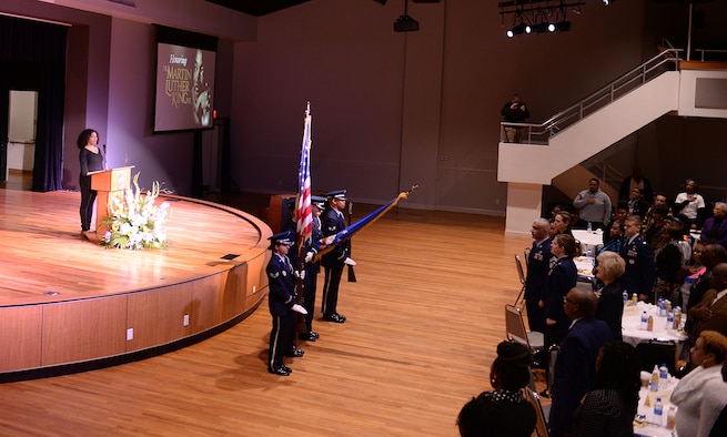 Capt. Alisha Foster, 14th Flying Training Wing Equal Opportunity director, sings the national anthem while the Columbus Air Force Base Honor Guard presents the colors during the MLK Commemoration Breakfast Jan. 21, 2019, at the Trotter Convention Center in Columbus, Mississippi. The MLK Commemoration Breakfast is an annual community collaboration to honor Martin Luther King Jr. as a national day of service. (U.S. Air Force photo by Airman Hannah Bean)