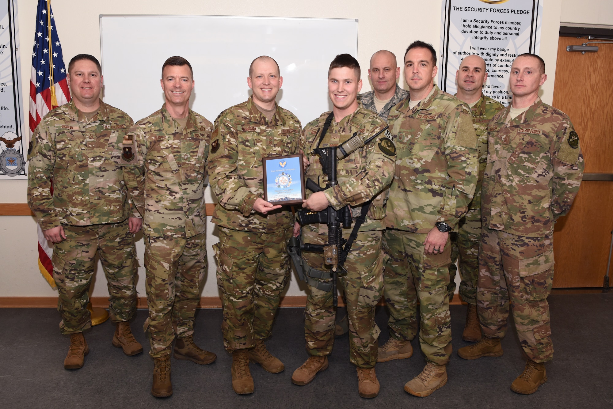 U.S. Air Force Airman 1st Class Nicolas Bood, 377th Weapons System Security Squadron, receives the December Diamond Sharp award from Senior Master Sgt. Michael Rumora, 377th WSSS first sergeant, at Kirtland Air Force Base, N.M., Jan. 24, 2019. Bood has used his short time in the Air Force to complete his Community College of the Air Force degree in criminal justice, and organized and recruited 19 volunteers for a holiday event. With his help, over 500 pounds of food was gathered. (U.S. Air Force photo by Senior Airman Eli Chevalier)