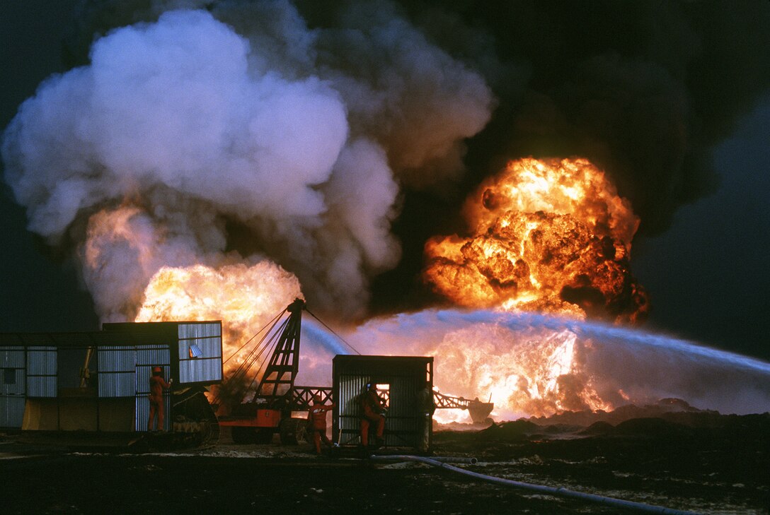 Personnel from Santa Fe Drilling Company and Red Adair Oil Well firefighters battle blaze from burning oil well set afire by Iraqi forces prior to their retreat
from Kuwait during Operation Desert Storm (DOD/Dick Moreno)