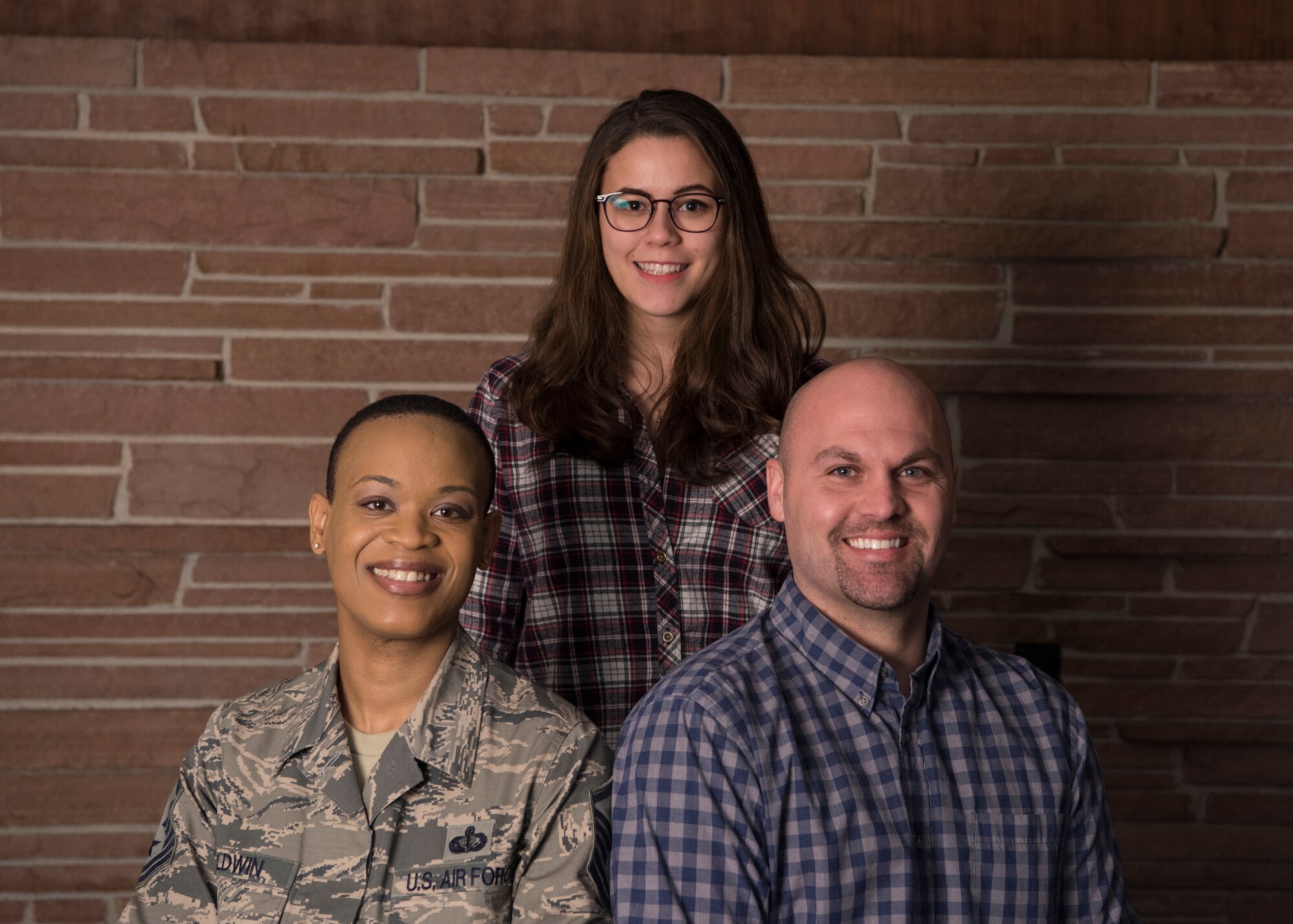 The Warhawk Community Center (WCC) staff pose for a group photo at Offutt Air Force Base, Nebraska, Jan. 25, 2019. The WCC is located in what you use to be the Patriot Club. (U.S. Air Force photo by Senior Airman Jacob Skovo)