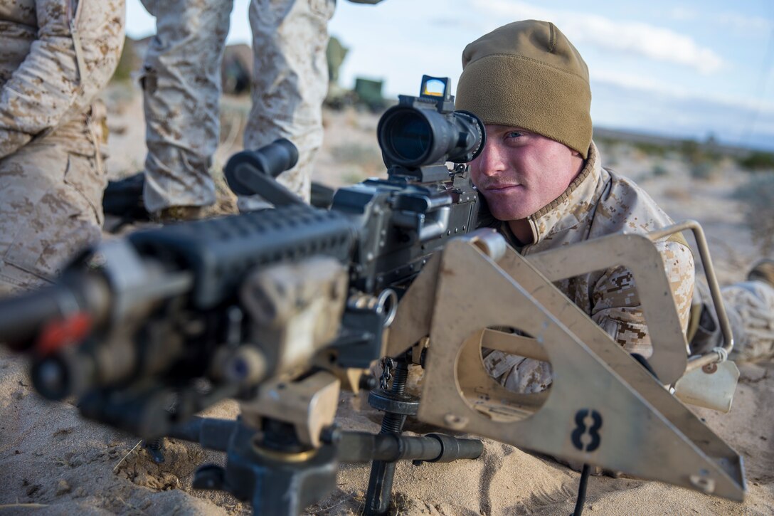 A U.S. Marine with Headquarters Battery, 11th Marine Regiment, sights in on an M240B machine gun to demonstrate proper weapons handling during exercise Steel Knight (SK) 2019 at Marine Corps Air Ground Combat Center, Twentynine Palms, California, Nov. 30, 2018.