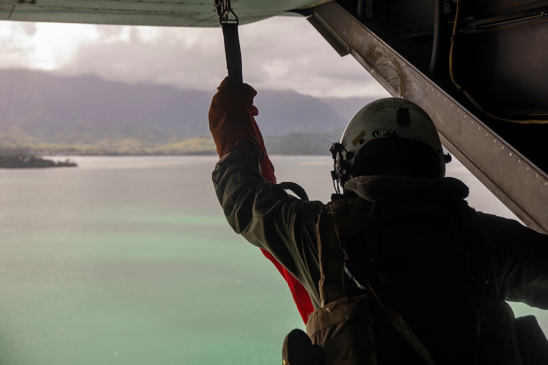 A U.S. Marine Corps crew chief with Marine Medium Tiltrotor Squadron 363 prepares a hoist hook, Marine Corps Air Station Kaneohe Bay, Marine Corps Base Hawaii, Jan. 24, 2019. The purpose of this training is to enhance evacuation capabilities of personnel utilizing the MV-22B Osprey in the event of a military or civilian mishap at sea. The ability to hoist stranded individuals from the water with tiltrotor aircraft provides additional life-saving response options for Hawaii-based Marine’s and the III Marine Expeditionary Force. (U.S. Marine Corps photo by Cpl Brendan Custer)