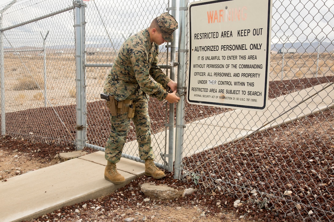 Noncommissioned Officer of the Quarter Cpl. Justin J. Zavala unlocks the gate surrounding the armory aboard Marine Corps Logistics Base Barstow, Calif, Jan. 15. As armory chief, Zavala must ensure each weapon is in working order. His dedication to his job and the best practices he has instituted at the armory are part of the reason he was chosen as NCO of the Quarter.