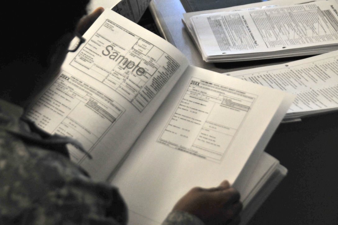 A service members looks at tax forms.