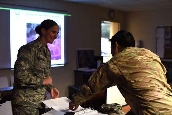 U.S. Air Force 2nd Lt. Katelyn Flanagan, 315th Training Squadron Student, asks Capt. Rick Rebulanan, 17th Training Wing chief of international training, questions after reviewing an assignment at the International Training Center on Goodfellow Air Force Base, Texas, Jan. 11, 2019. When an exercise is completed the students are welcome to discuss any of the concepts with in the class or the instructors. (U.S. Air Force photo by Senior Airman Seraiah Hines/Released)