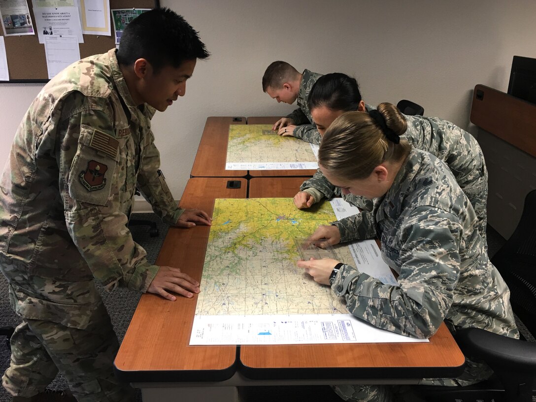 U.S. Air Force Capt. Ric Rebulanan, 17th Training Wing chief of international training, explains to students how to read maps as a part of the updating of the International Intelligence Applications Officers Course. (Courtesy photo)
