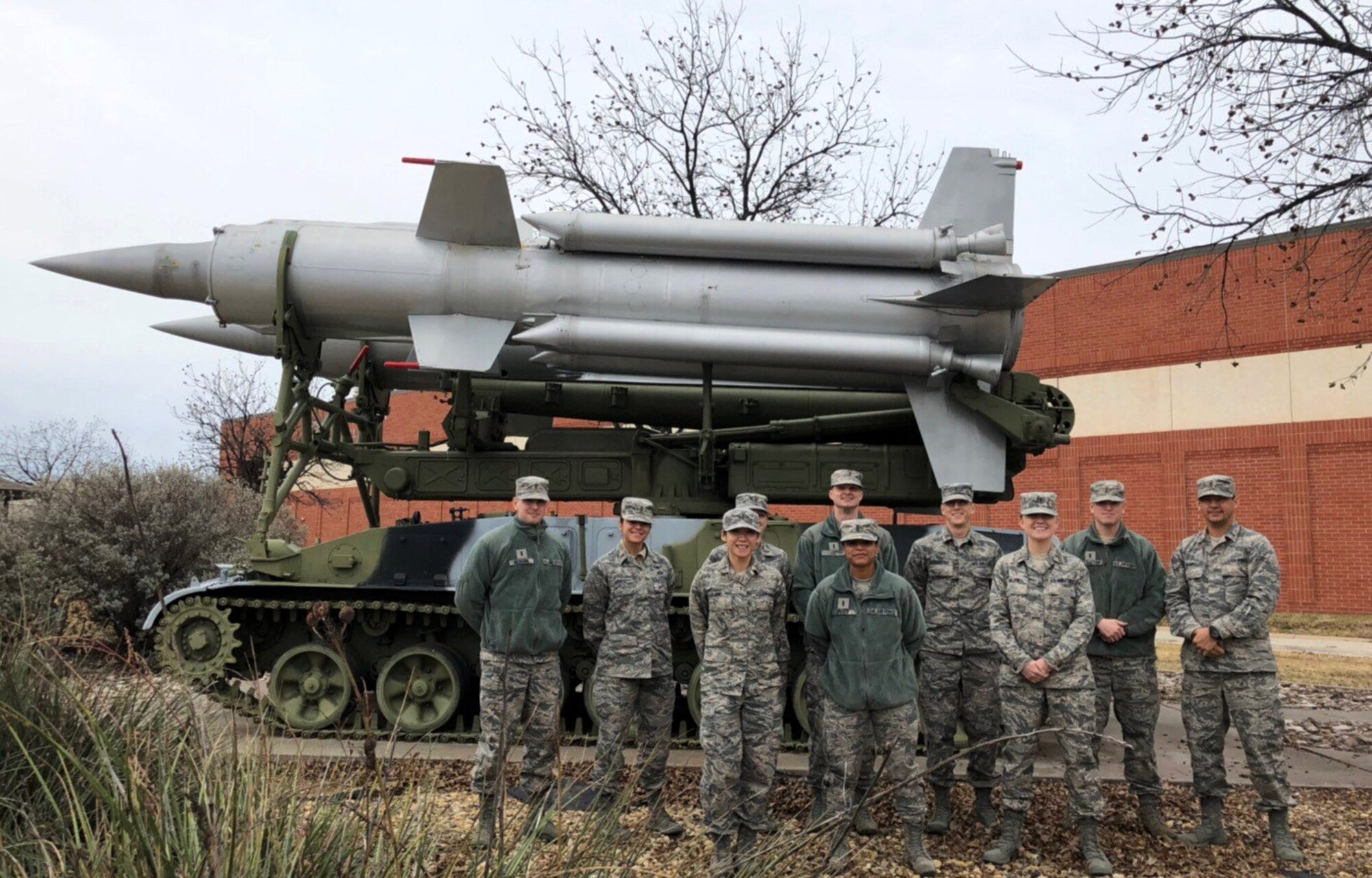 U.S. Air Force instructors and students part of the updating of the International Intelligence Applications Course stand in front of a static threat display of an SA-4 "Ganef" missile system. (Courtesy photo)
