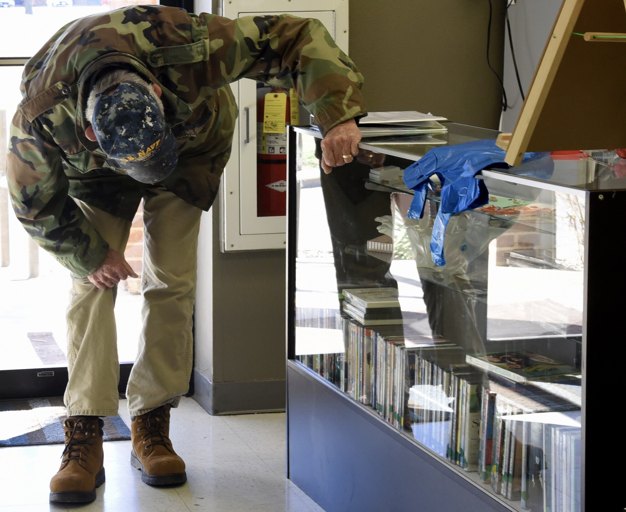Jack Farris, a retired military veteran views the new products inside the glass case at the Goodfellow Spouses’ Club Thrift Store on Goodfellow Air Force Base, Jan. 19, 2019. Farris and his wife regularly come to the thrift store on Saturdays.  (U.S. Air Force photo by Airman 1st Class Abbey Rieves/Released)