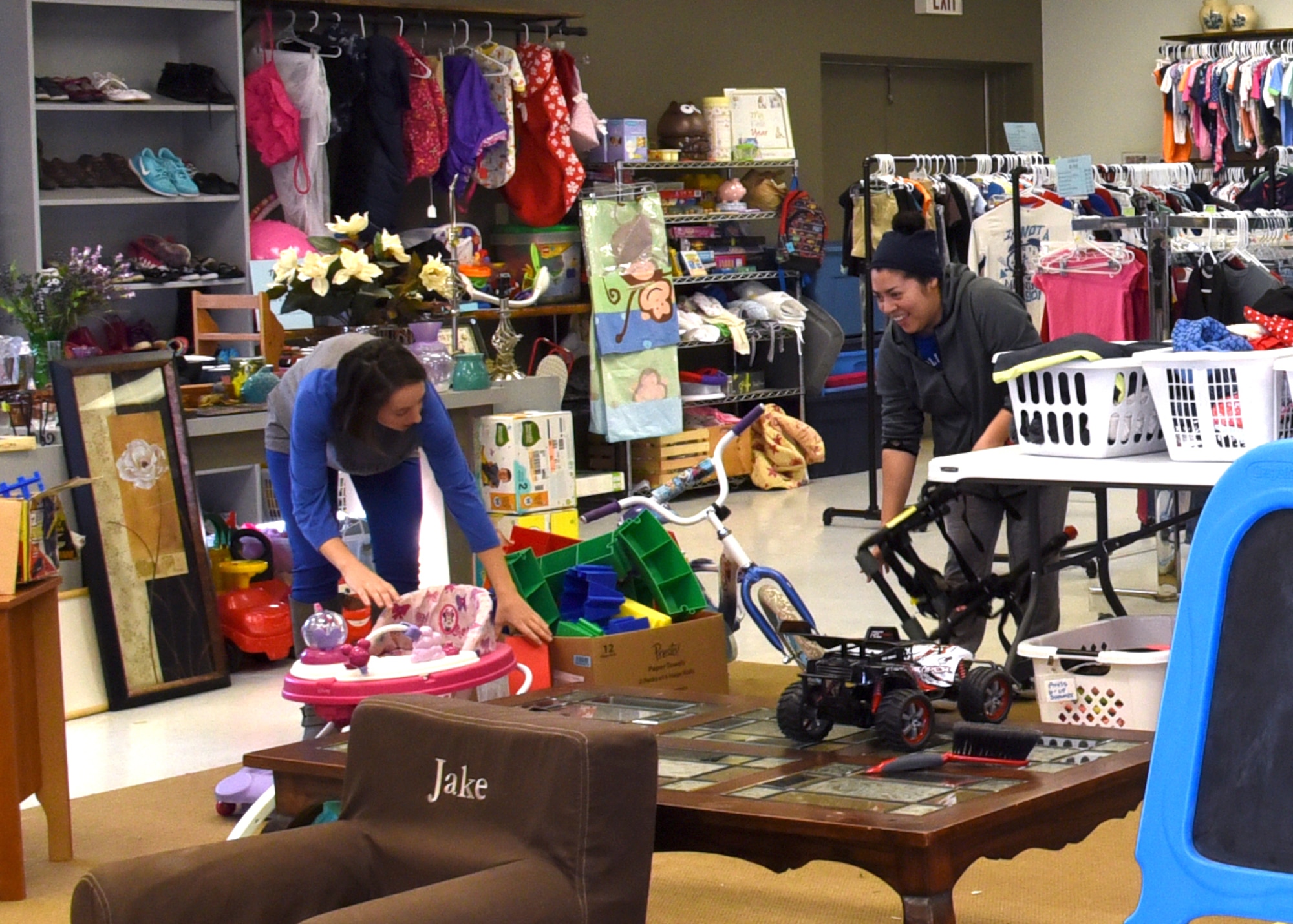 Kelsey Ostroski, Goodfellow Spouses’ Club president, directs Isla Red Horse, a housewife where to put new donations in the club’s thrift store on Goodfellow Air Force Base, Jan. 19, 2019.  The store receives multiple donations during the day and volunteers rapidly turn donated items into products for sale on the floor. (U.S. Air Force photo by Airman 1st Class Abbey Rieves/Released)