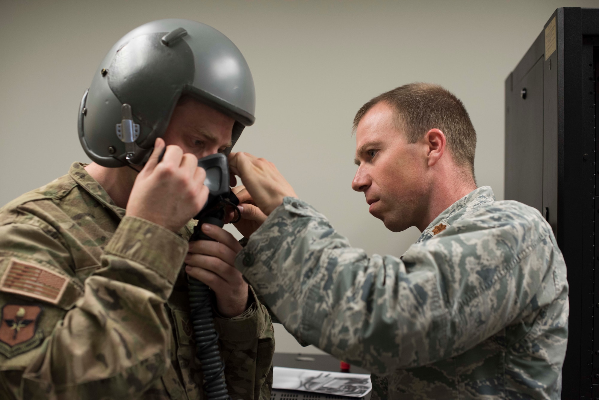 Maj. Zachary Garrett, 49th Medical Group Human Performance flight commander, fits a mask for Tech. Sgt. Jonathan Andrew, 49th MDG Education and Training flight chief, Jan. 11, 2019, on Holloman Air Force Base, N.M. As an aerospace physiologist, Garrett conducts hypoxia recognition and recovery training and studies human factors in the flight environment for 49th Wing aircrew. (U.S. Air Force photo by Staff Sgt. BreeAnn Sachs)