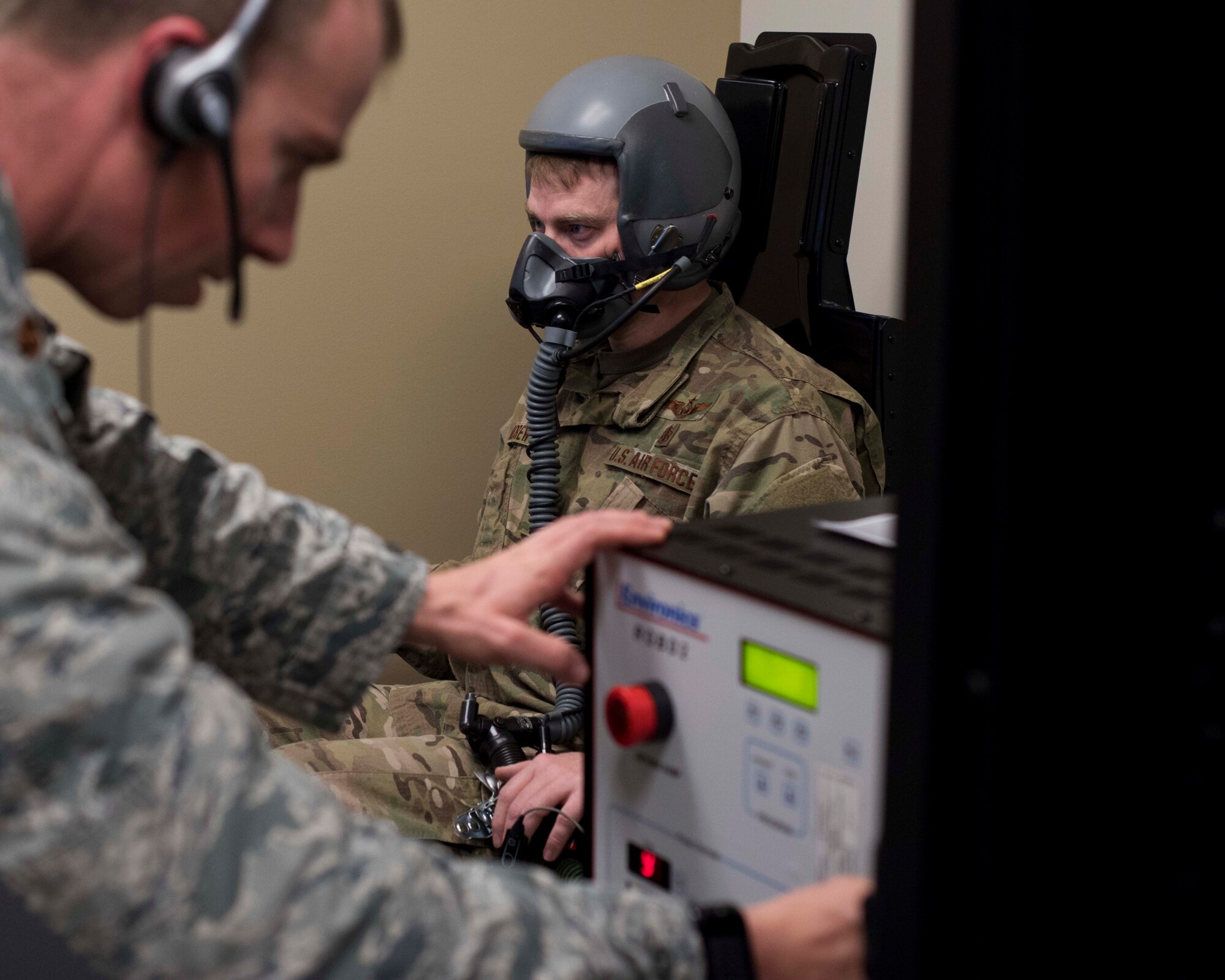 Maj. Zachary Garrett, 49th Medical Group Human Performance flight commander, adjusts the oxygen level during a hypoxia recognition simulation for Tech. Sgt. Jonathan Andrew, 49th MDG Education and Training flight chief, Jan. 11, 2019, on Holloman Air Force Base, N.M. As an aerospace physiologist, Garrett conducts hypoxia recognition and recovery training and studies human factors in the flight environment for 49th Wing aircrew. (U.S. Air Force photo by Staff Sgt. BreeAnn Sachs)