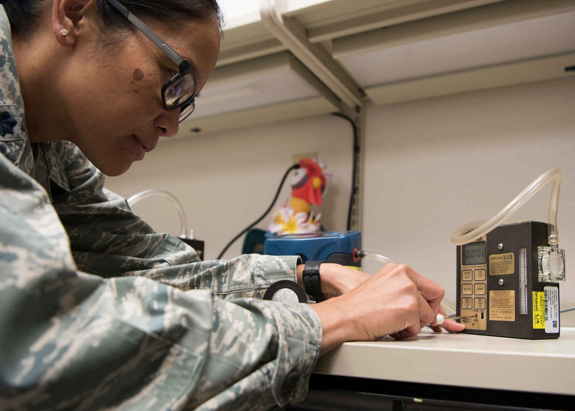 Lt. Col. Elisa Hammer, 49th Medical Group Biomedical Engineering flight commander, calibrates an air pump, Jan. 11, 2019, on Holloman Air Force Base, N.M. Biomedical engineers use air pumps to sample particulates in the air in various work places in an effort to find potentially hazardous contamination. (U.S. Air Force photo by Staff Sgt. BreeAnn Sachs)