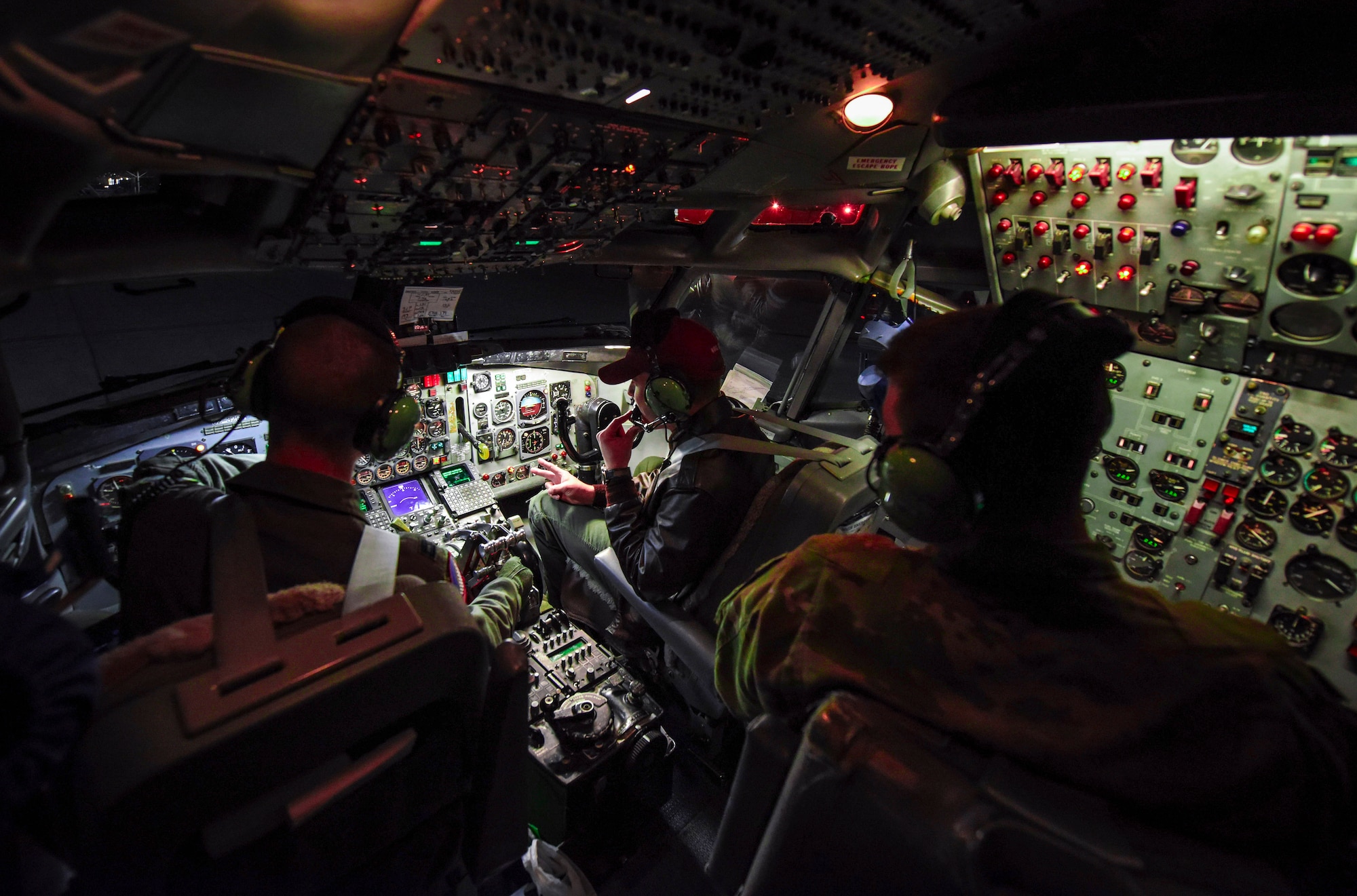 Pilots sit in the cockpit of a E-8C Joint STARS aircraft.